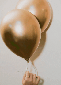 In this example, by selecting the "Solid Color Noise" mode, we add sparkles to a GIF of golden balloons. In the noise color field, we enter "yellow" and "orange", and in the noise strength field, we enter 2%. As a result, we get an animated GIF with 2% of all pixels randomly changed to yellow or orange. (Source: Pexels.)